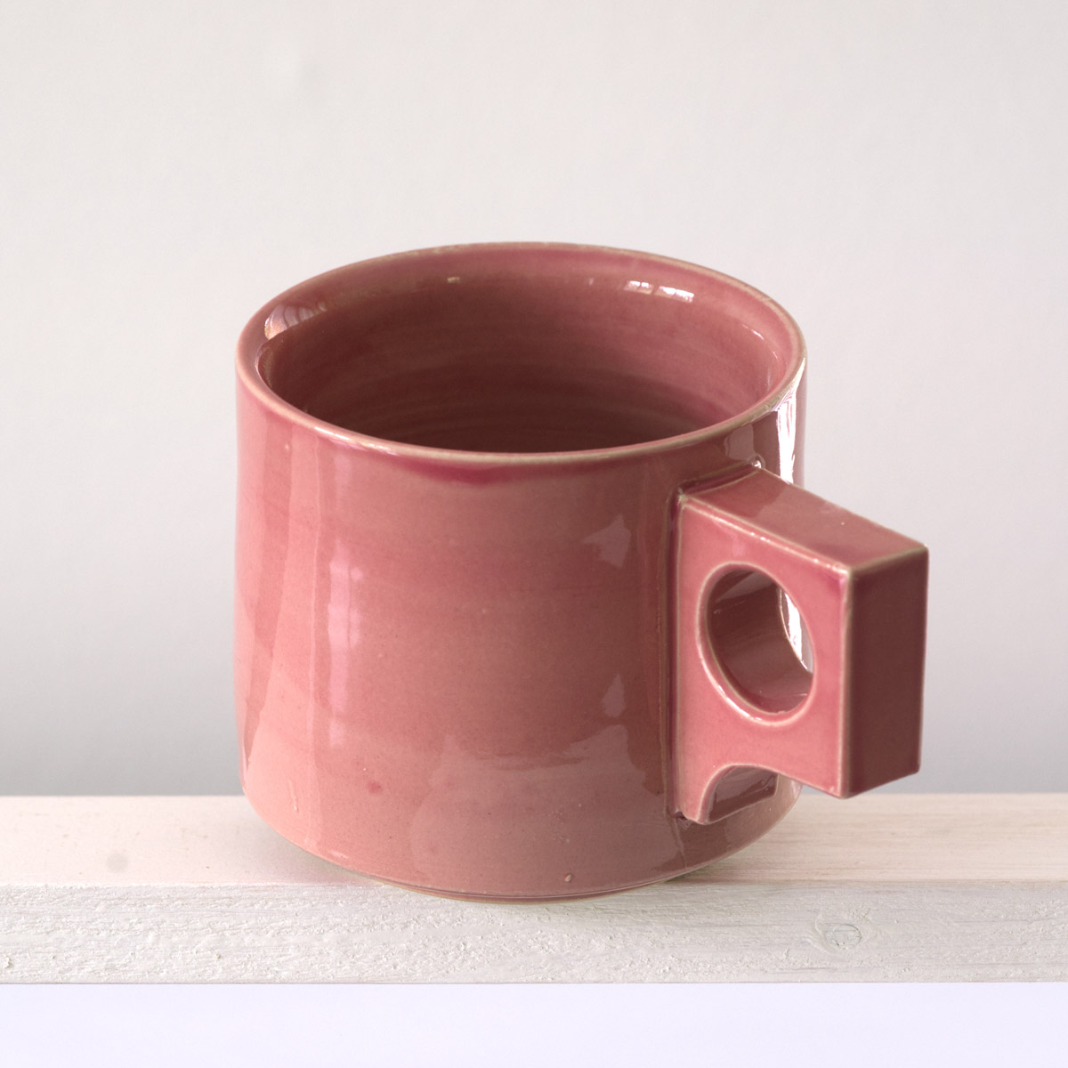 Schräge Ausicht auf eine große Tasse mit einer glänzenden, altrosefarbenen Glasur